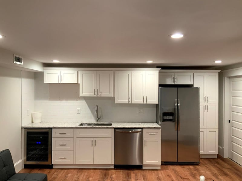 Kitchen in remodeled basement near Boston, MA by Honorato Company