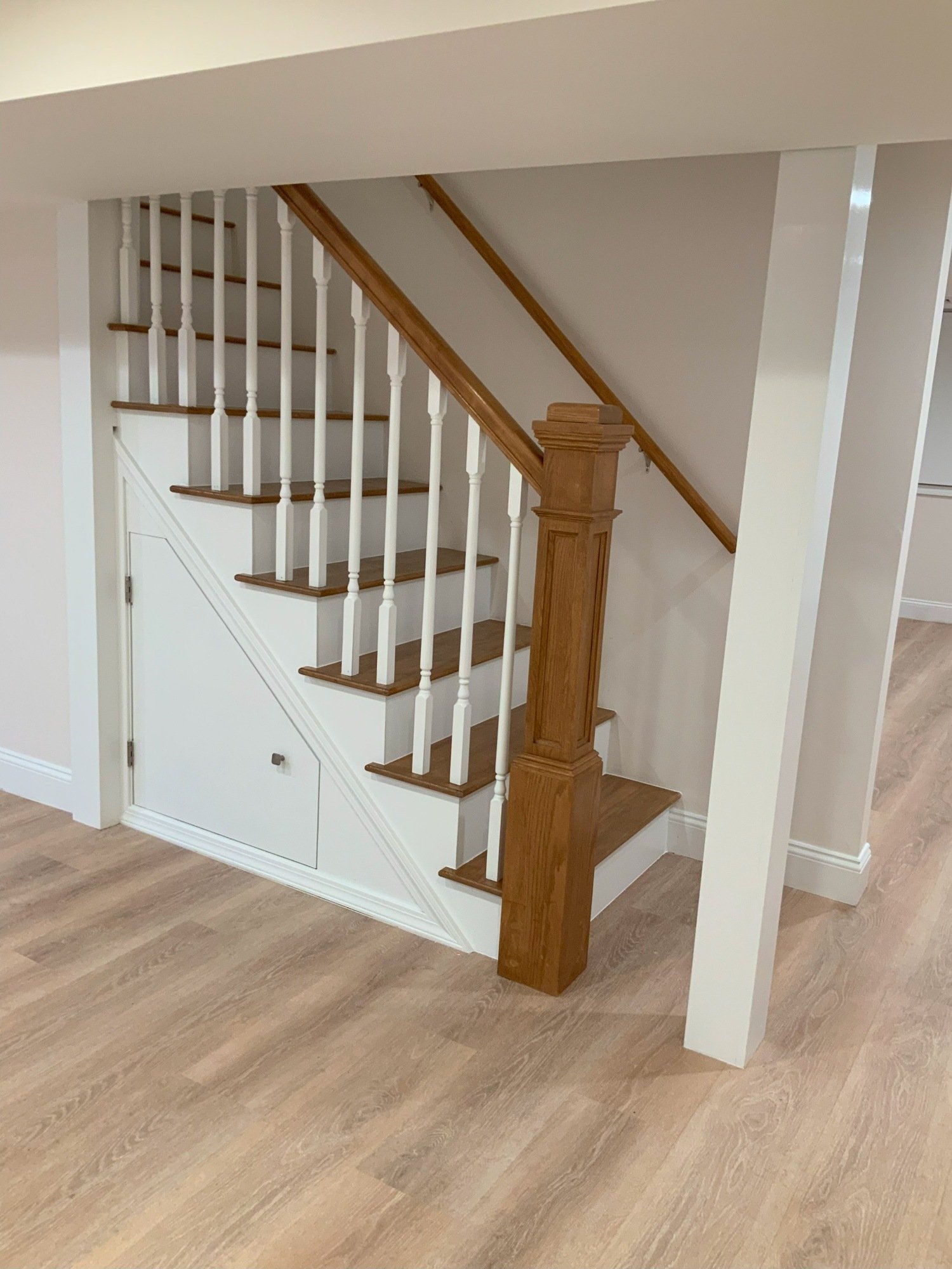 finished basement stairs with railing and storage