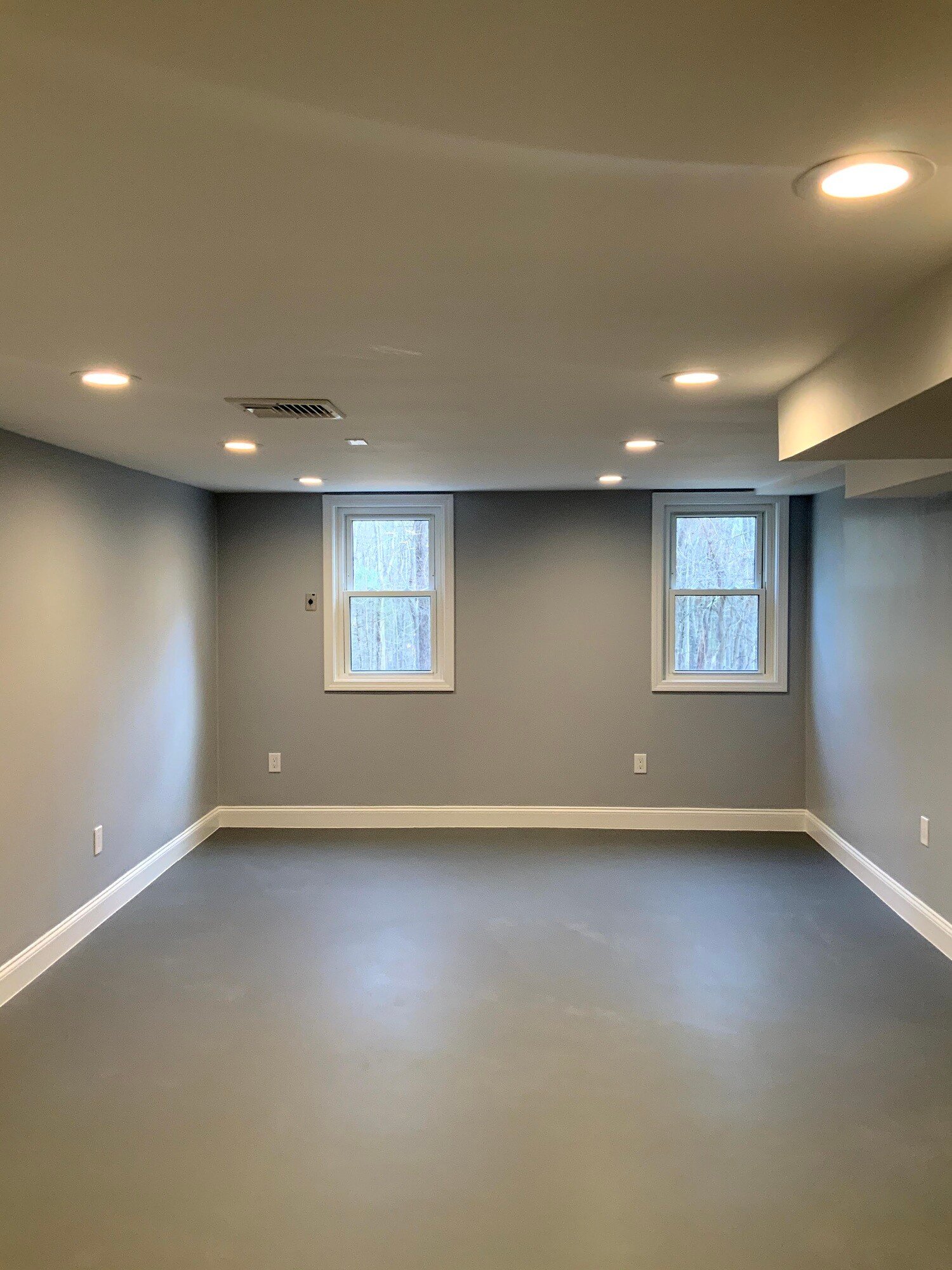 new bedroom with windows in remodeled basement