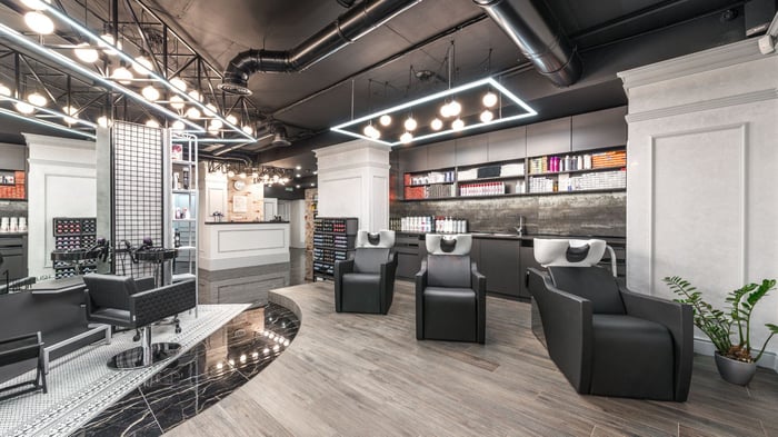 Commercial renovation interior with backwash chairs in modern beauty salon by Honorato Company