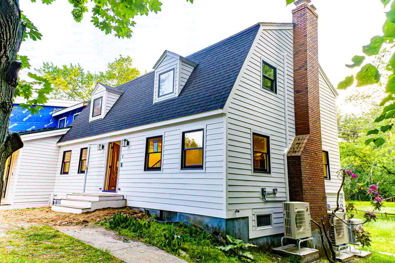 Exterior of Boston, MA home remodel by Honorato Company with white siding
