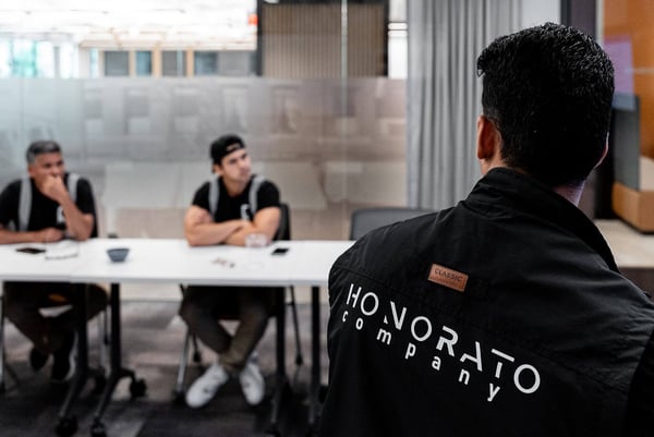 Focused view of Honorato Company jacket with Boston office in background