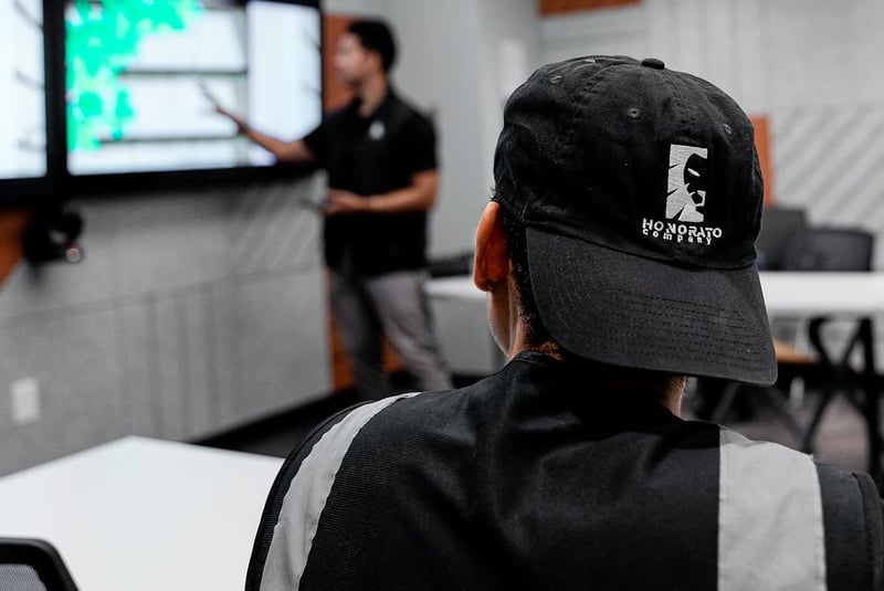 Focused view of company hat with Boston office in background