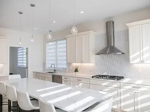 White kitchen remodel with island in Boston by Honorato Company