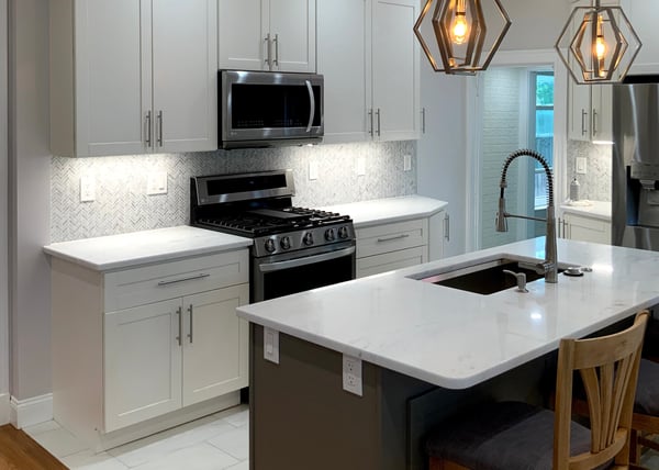 small white kitchen remodel in Greater Boston, MA with island and stainless appliances by Honorato Company