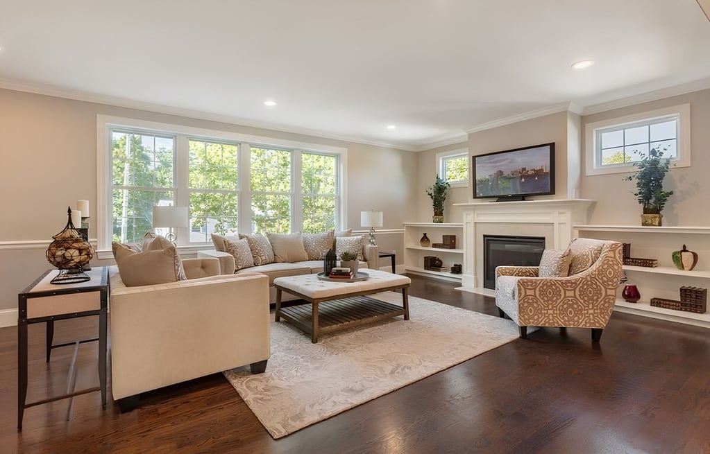 Main floor living room with wood flooring in Boston home by Honorato Company