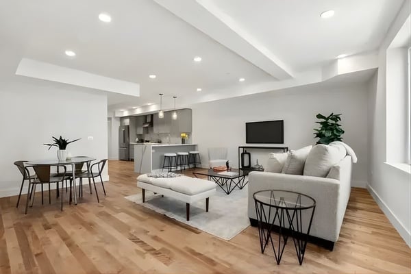 Modern open-concept condo with hardwood floors, neutral decor, and updated kitchen located in the Boston area