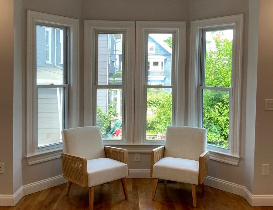 Two chairs in front of window in Greater Boston, MA home remodel by Honorato Company-1