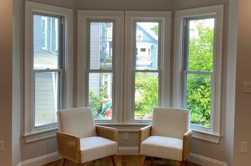 Two chairs in front of window in Greater Boston, MA home remodel by Honorato Company