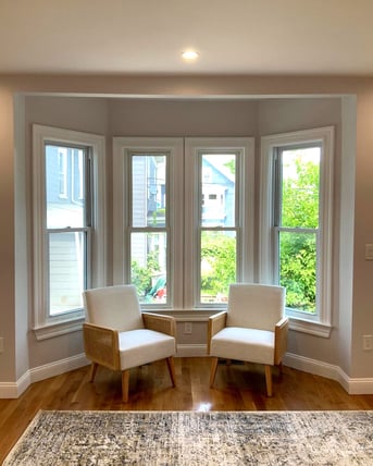Two chairs in front of window in Greater Boston, MA home remodel by Honorato Company