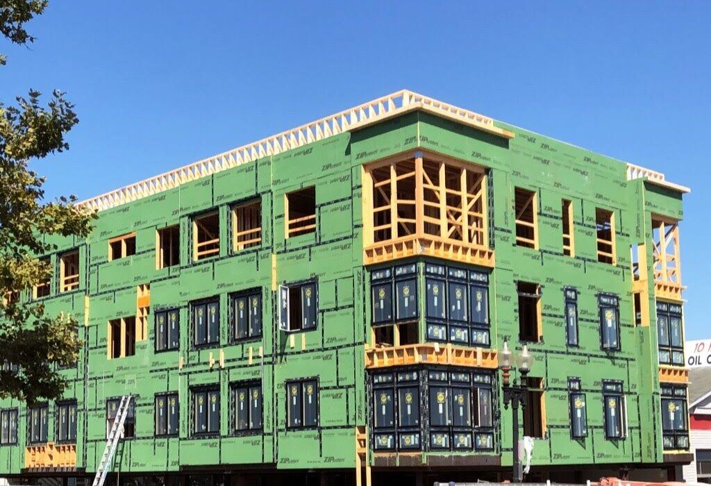 Exterior of condo construction during day near Boston, MA by Honorato Company